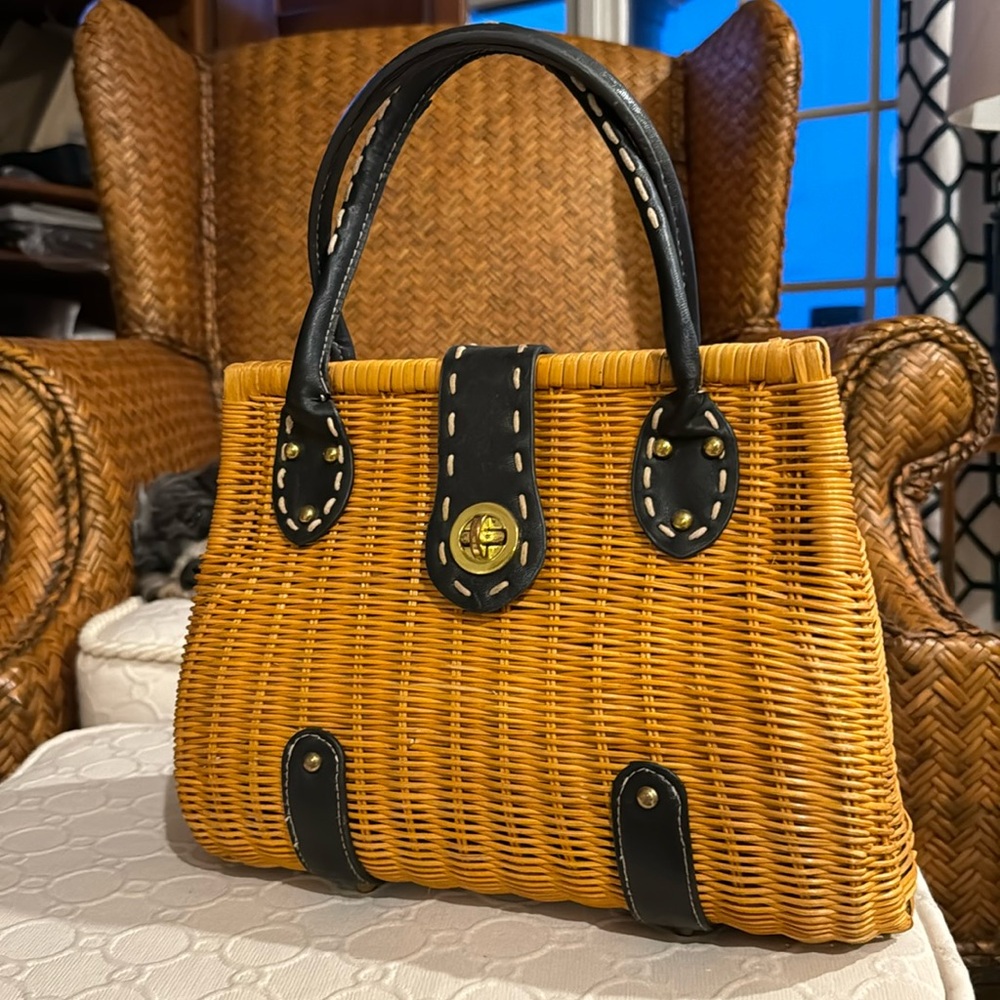 Vintage straw handbags with blue leather handles straps.
